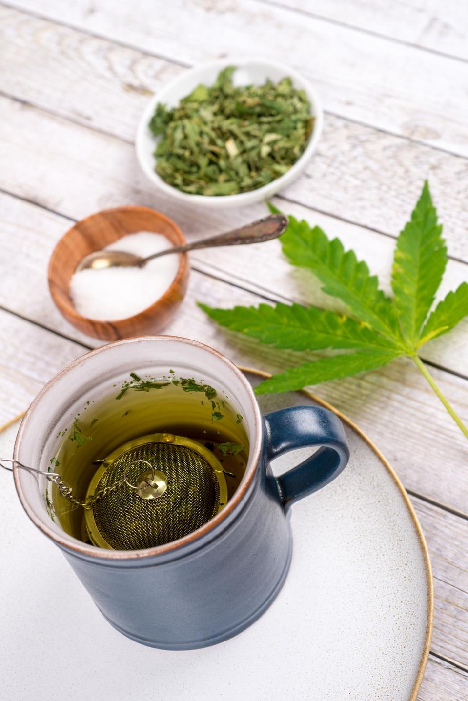 Cannabis tea with cup and tea strainer - cannabis, marijuana