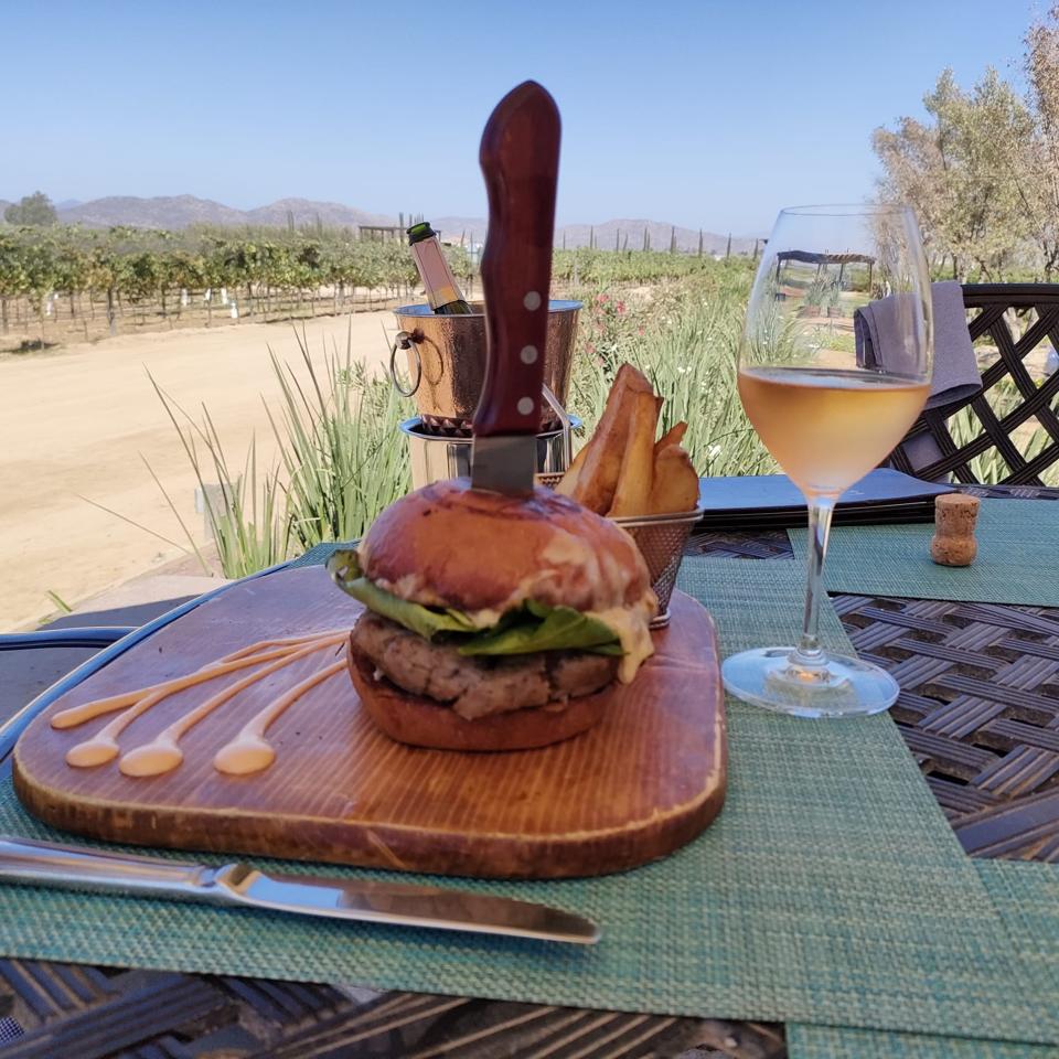 a burger on a plate in an outdoor restaurant