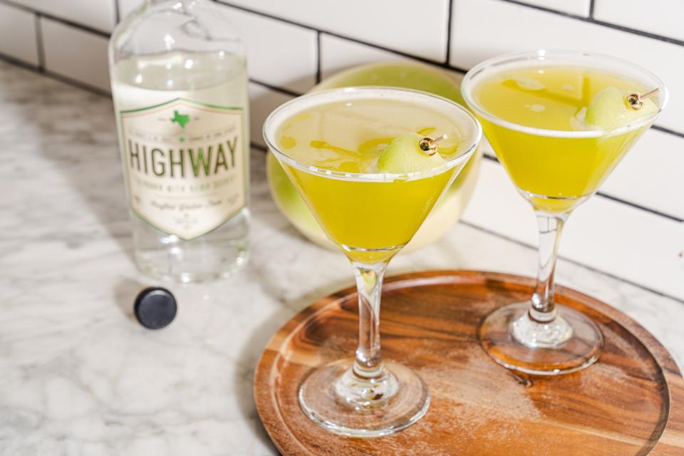 a tray with cocktails and bottle of vodka