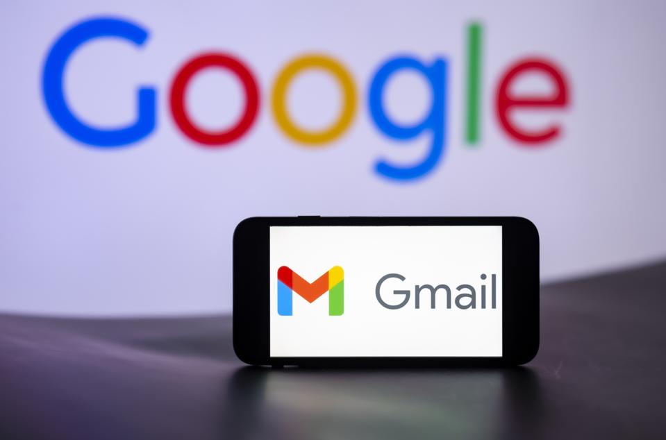 Gmail logo is seen displayed on a mobile phone screen with Google Logo in the background.