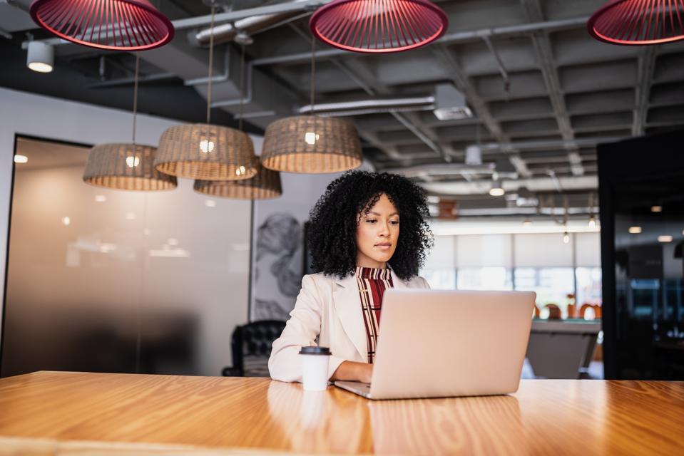 Businesswoman using laptop working at office