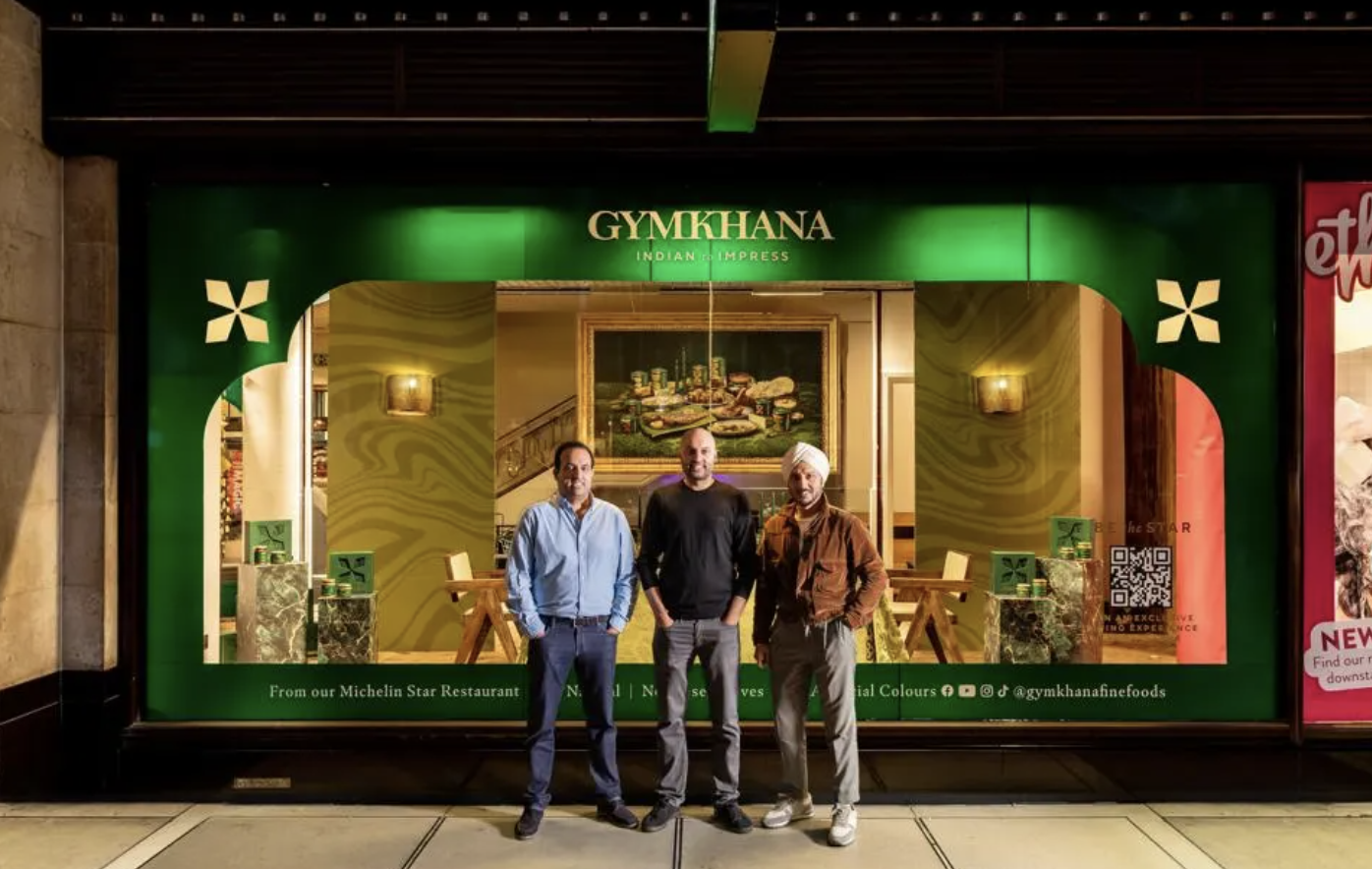 Three men stand in front of Gymkhana Fine Foods