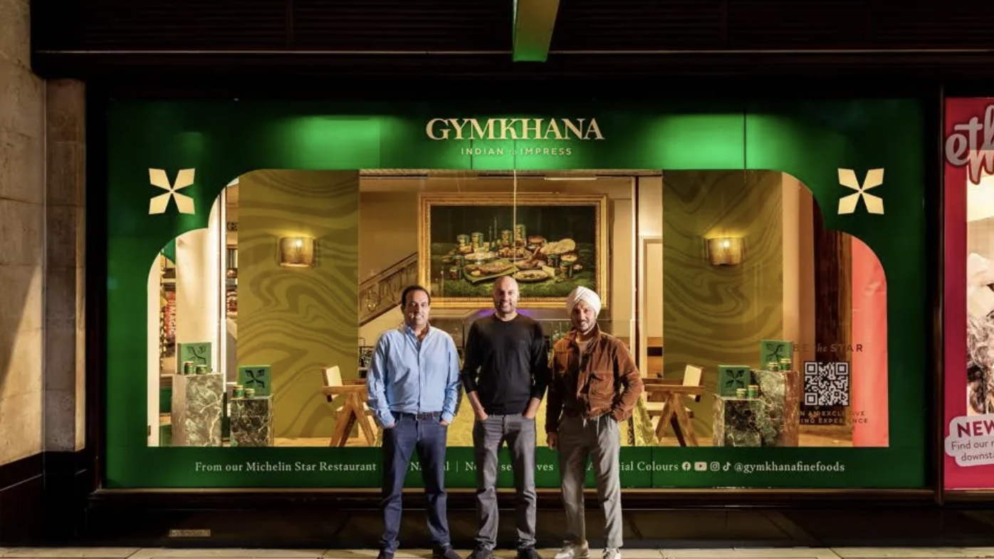 Three men stand in front of Gymkhana Fine Foods