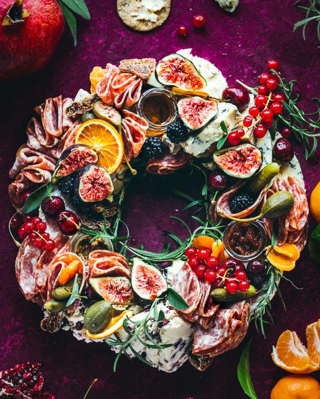 A wreath made of  different colors fruits.