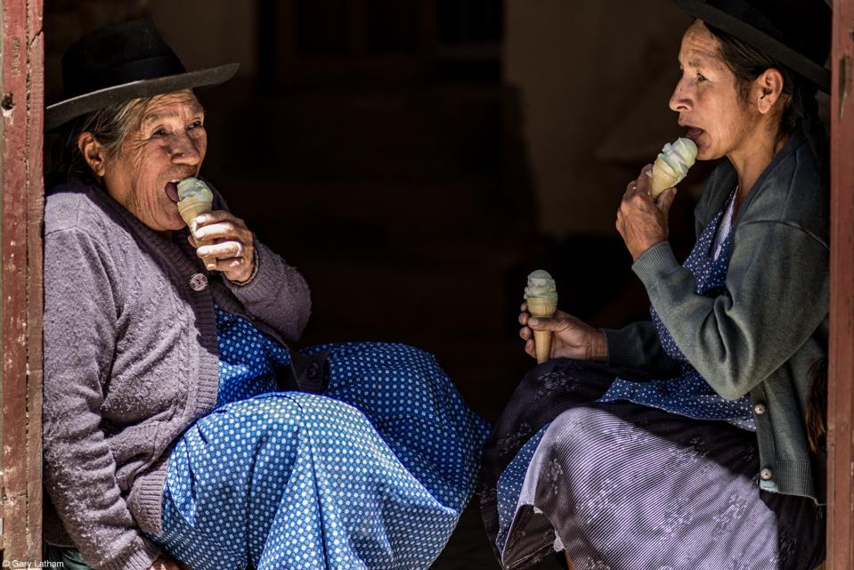 Local women enjoying ice cream at the Ice cream-Pujllay Festival in Tarabuco, Bolivia