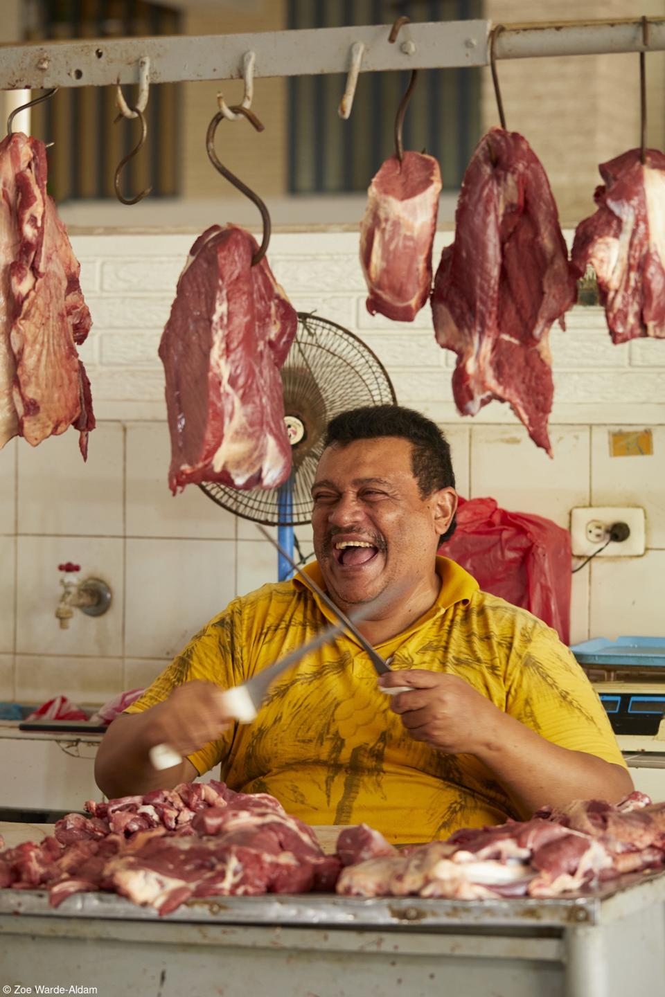 A man sharpening knives at his butchery in Santa Marta, Colombia