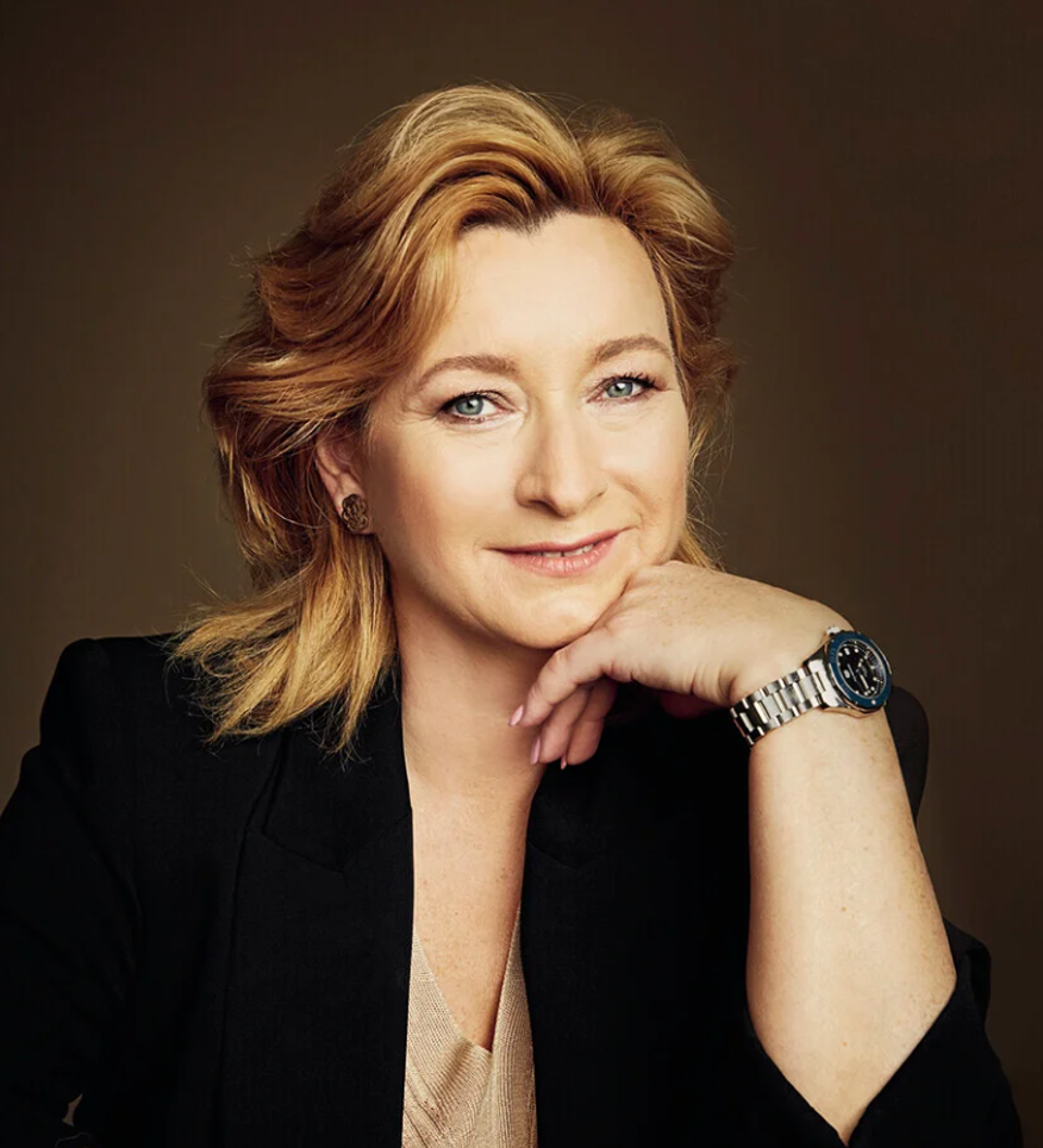 Renata Mrázová rests her chin on the back of her hand. She wears a black blazer.