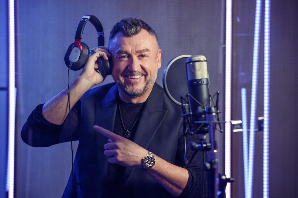 Lubo Kirov uses recording studio equipment and wears a dark blazer.