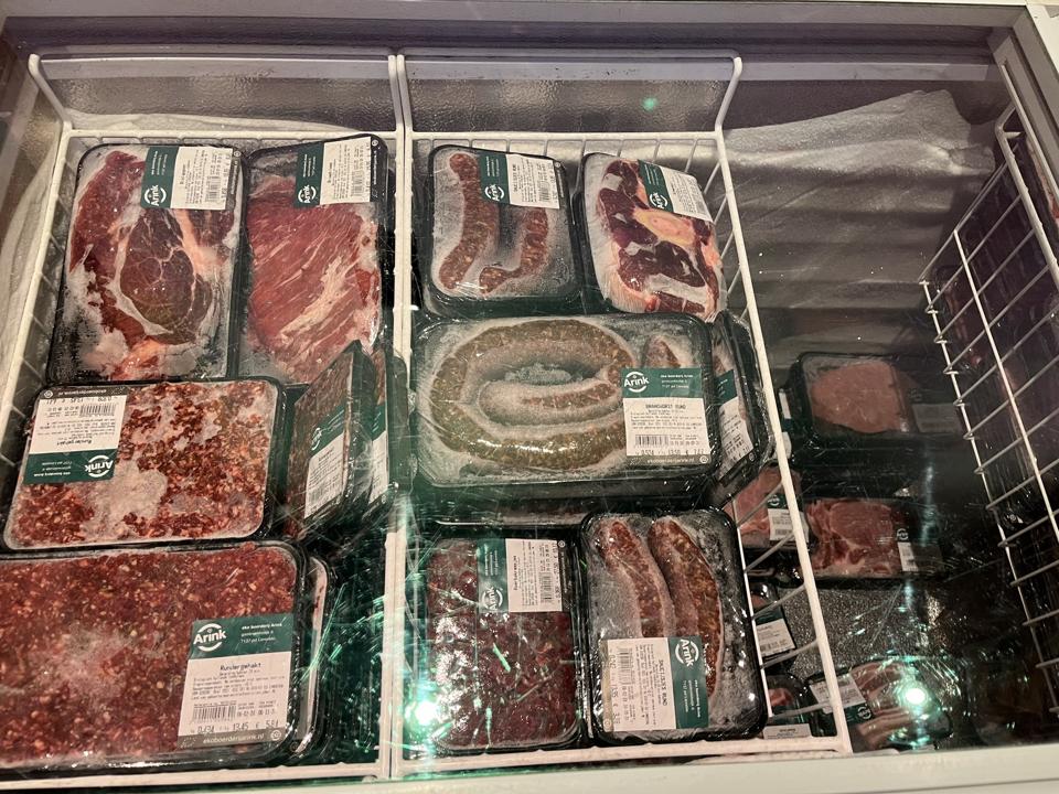A small freezer with packages of meat products