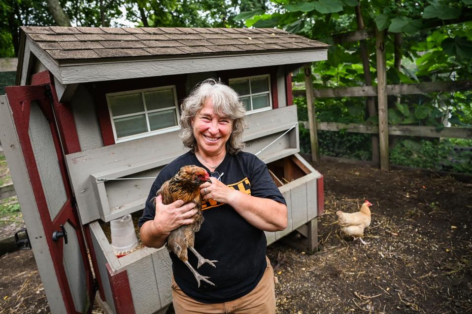 Long Island woman holds one of her backyard hens