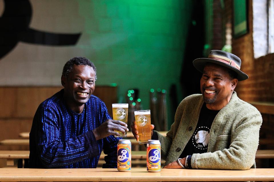 Pierre Thiam and Garrett Oliver enjoy pints of Brooklyn Brewery beer brewed with fonio.
