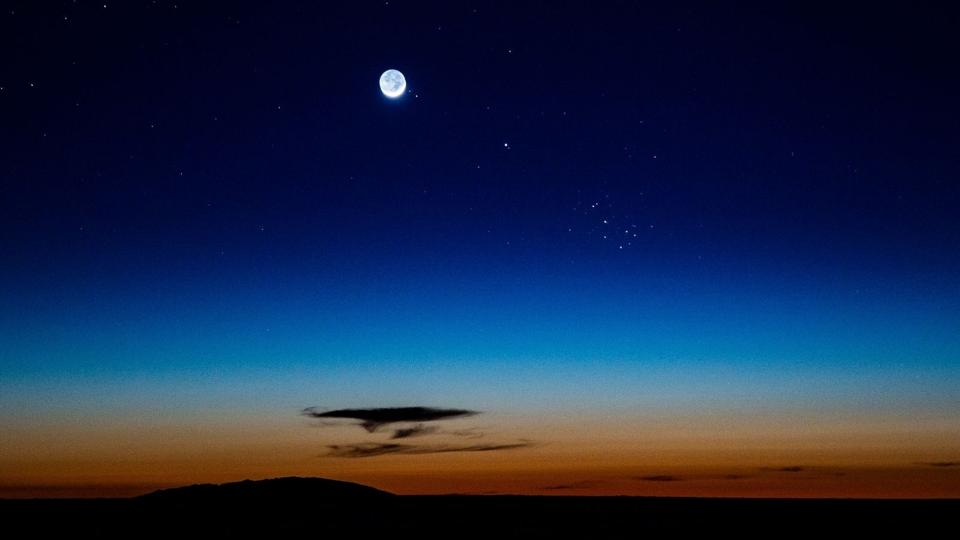 A crescent moon and the Pleiades.