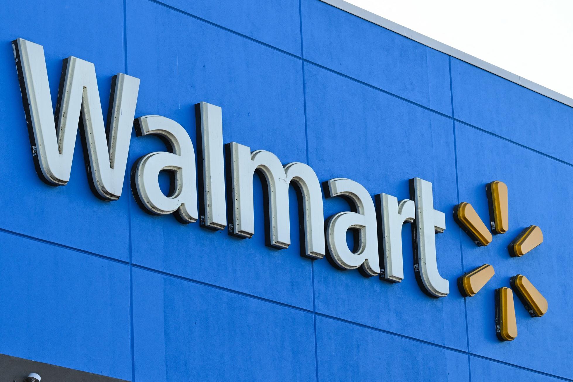 A close-up shot of the Walmart logo on a storefront.