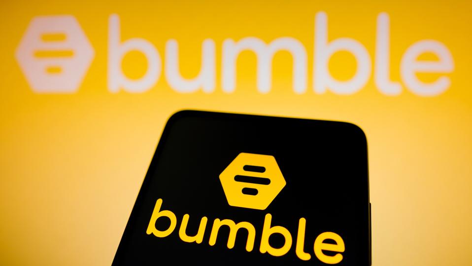 In this photo illustration the Bumble logo seen displayed on...