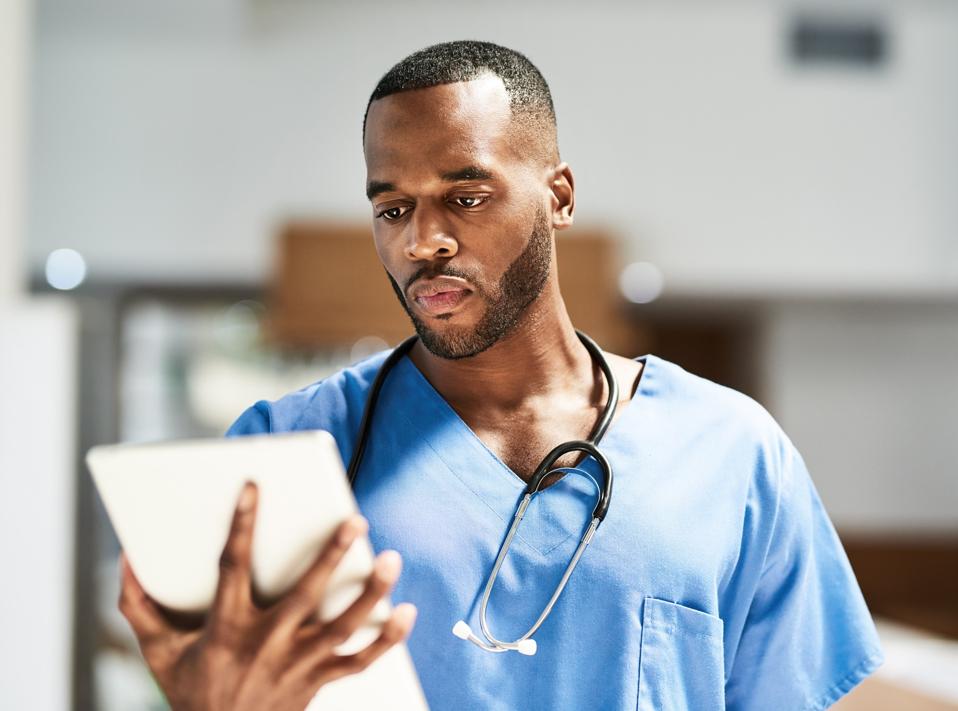 Keeping tabs on the progress of his patients wherever he goes