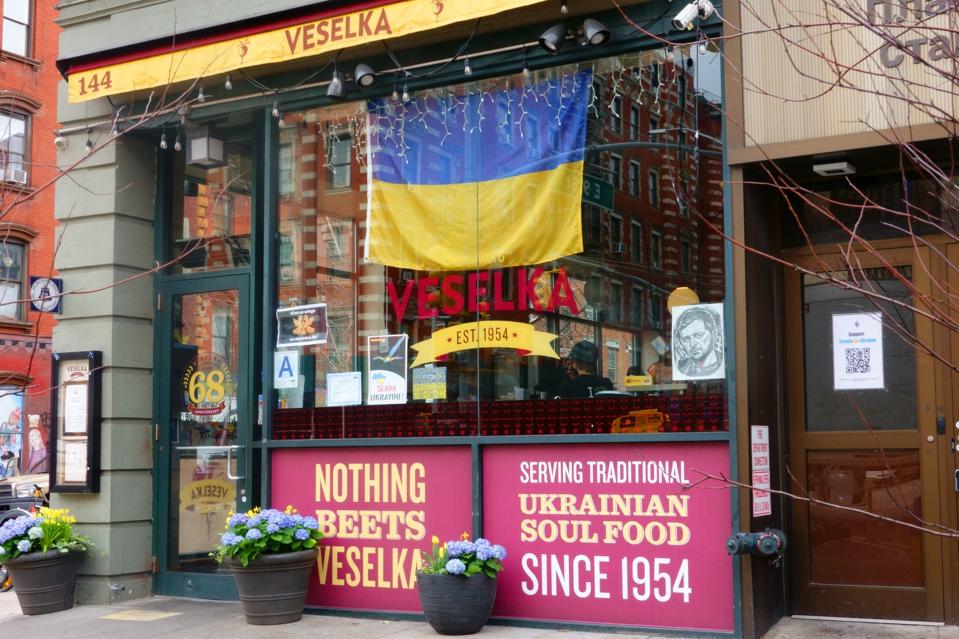 Entrance of Veselka Ukrainian Restaurant with large Ukrainian flag in window, Second Avenue, New York City