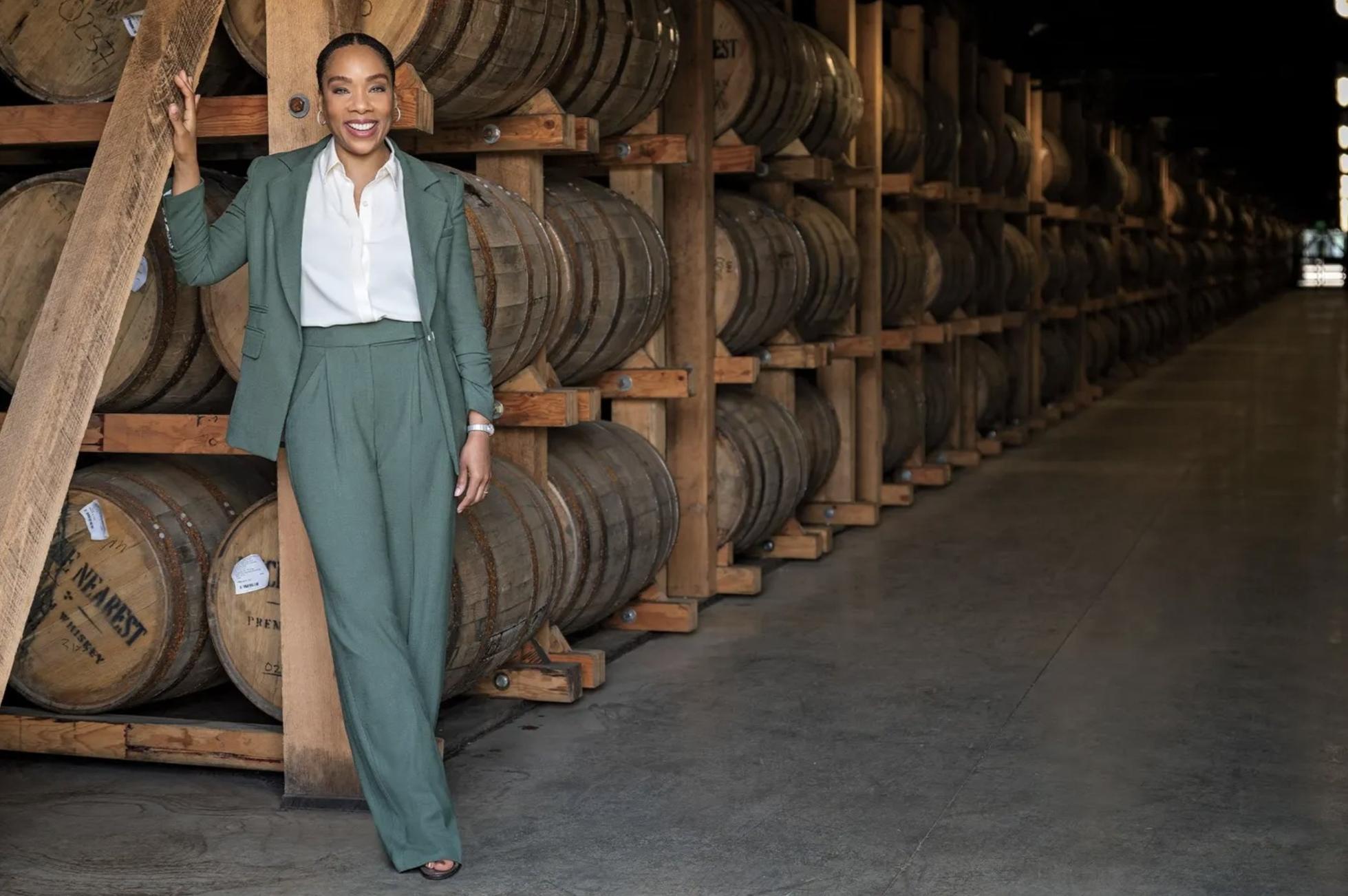 Fawn Weaver stands in front of whiskey barrels at the Uncle Nearest distillery.