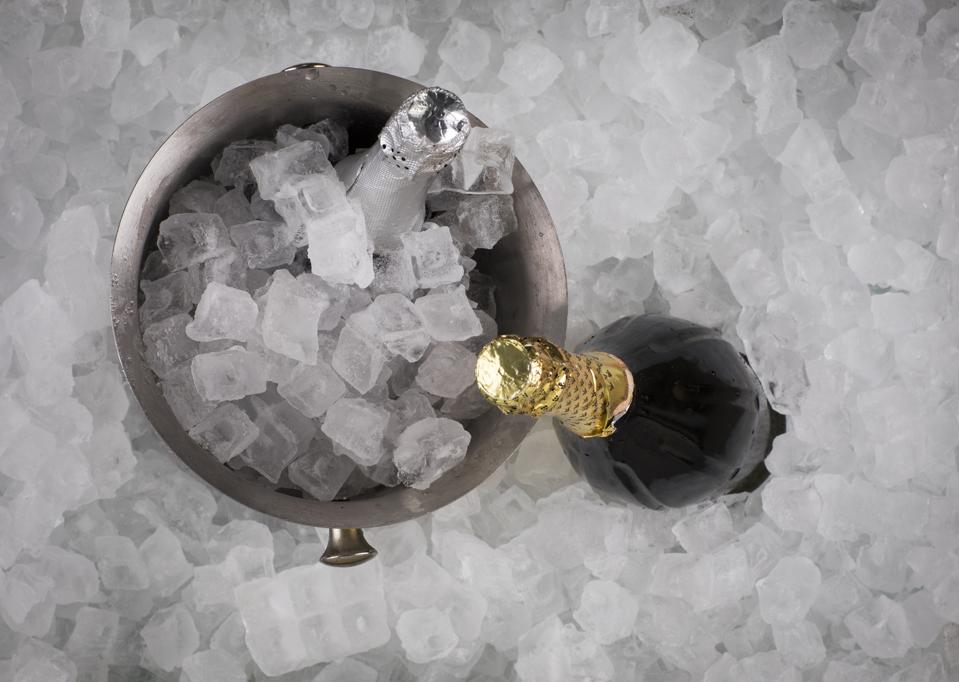 Bottle of champagne in cold ice cubes bucket