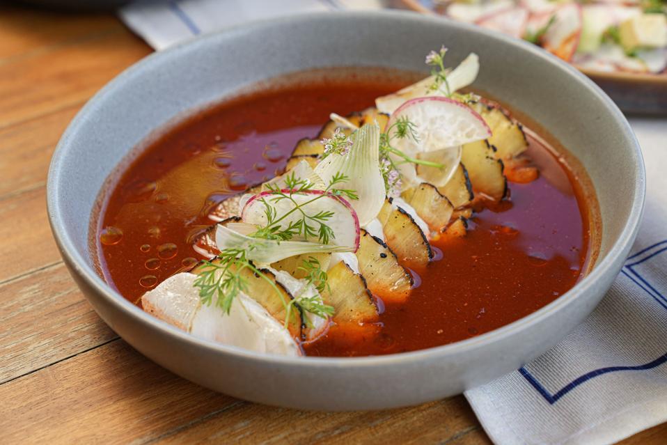 a tiradito dish with fish, pineapple and chile sauce