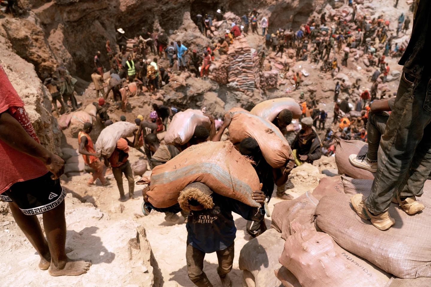 Artisanal miners carry sacks of ore at the Shabara artisanal mine near Kolwezi in 2022.