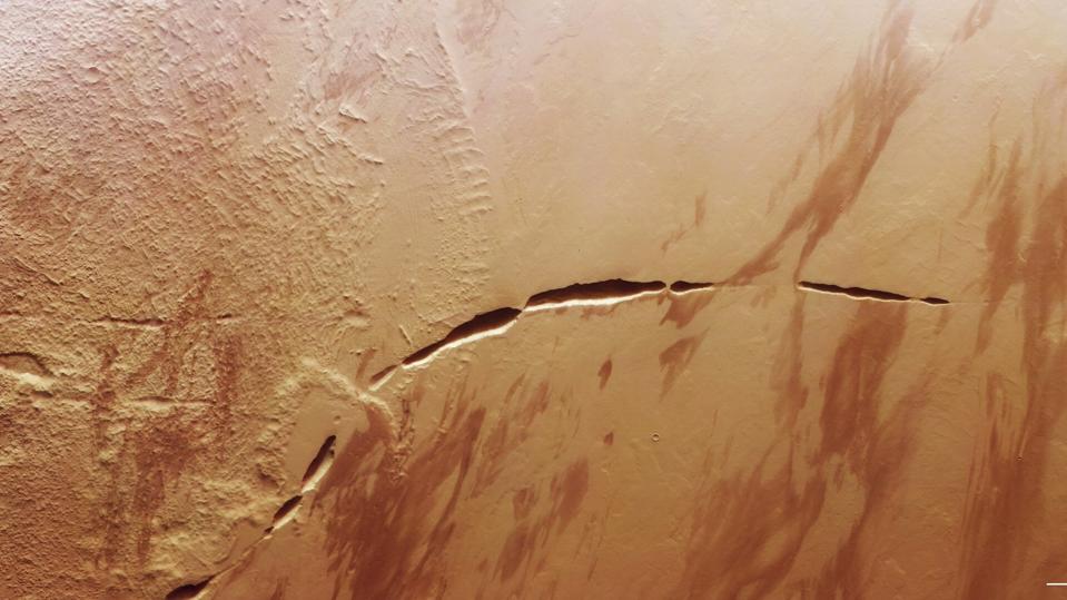 Mars Spacecraft Spots ‘Snaking Scar’ At The Foot Of A Massive Volcano