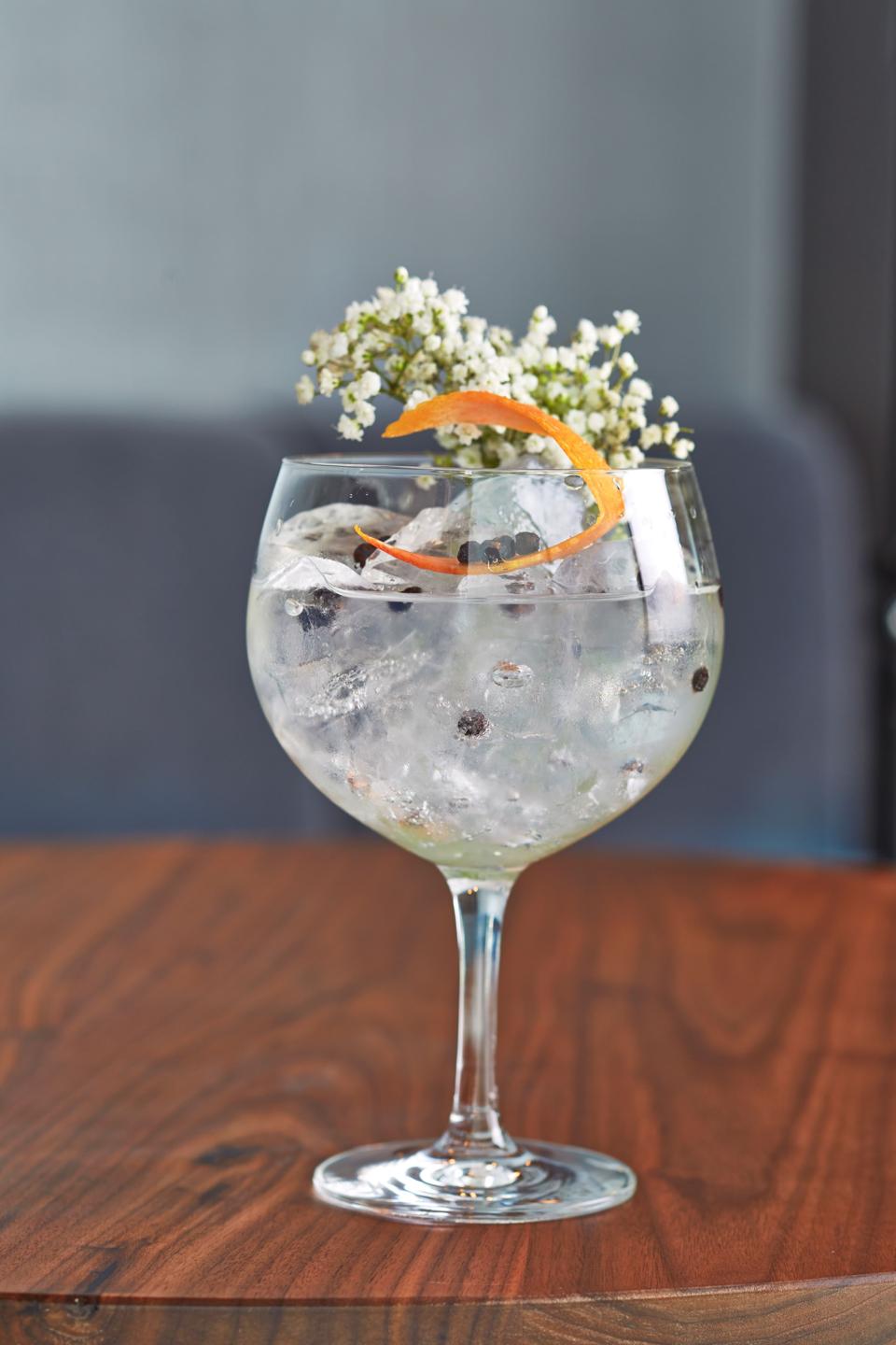 a clear cocktail in a wine glass