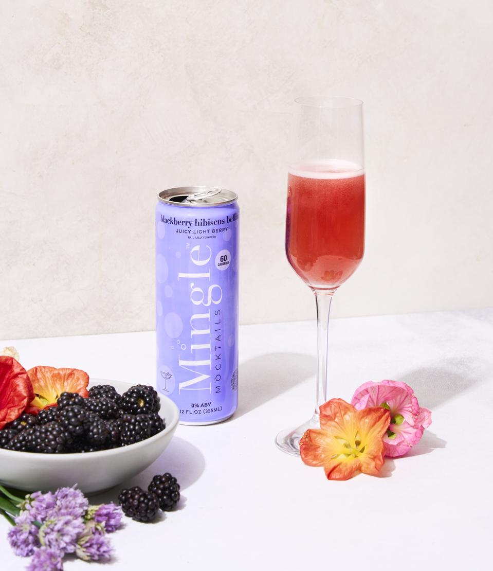 a can and a red cocktail in a glass.