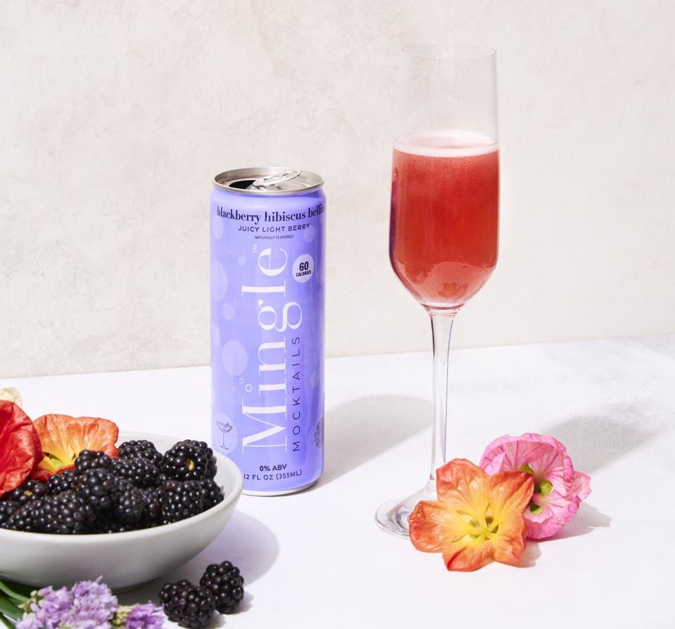 a can and a red cocktail in a glass.