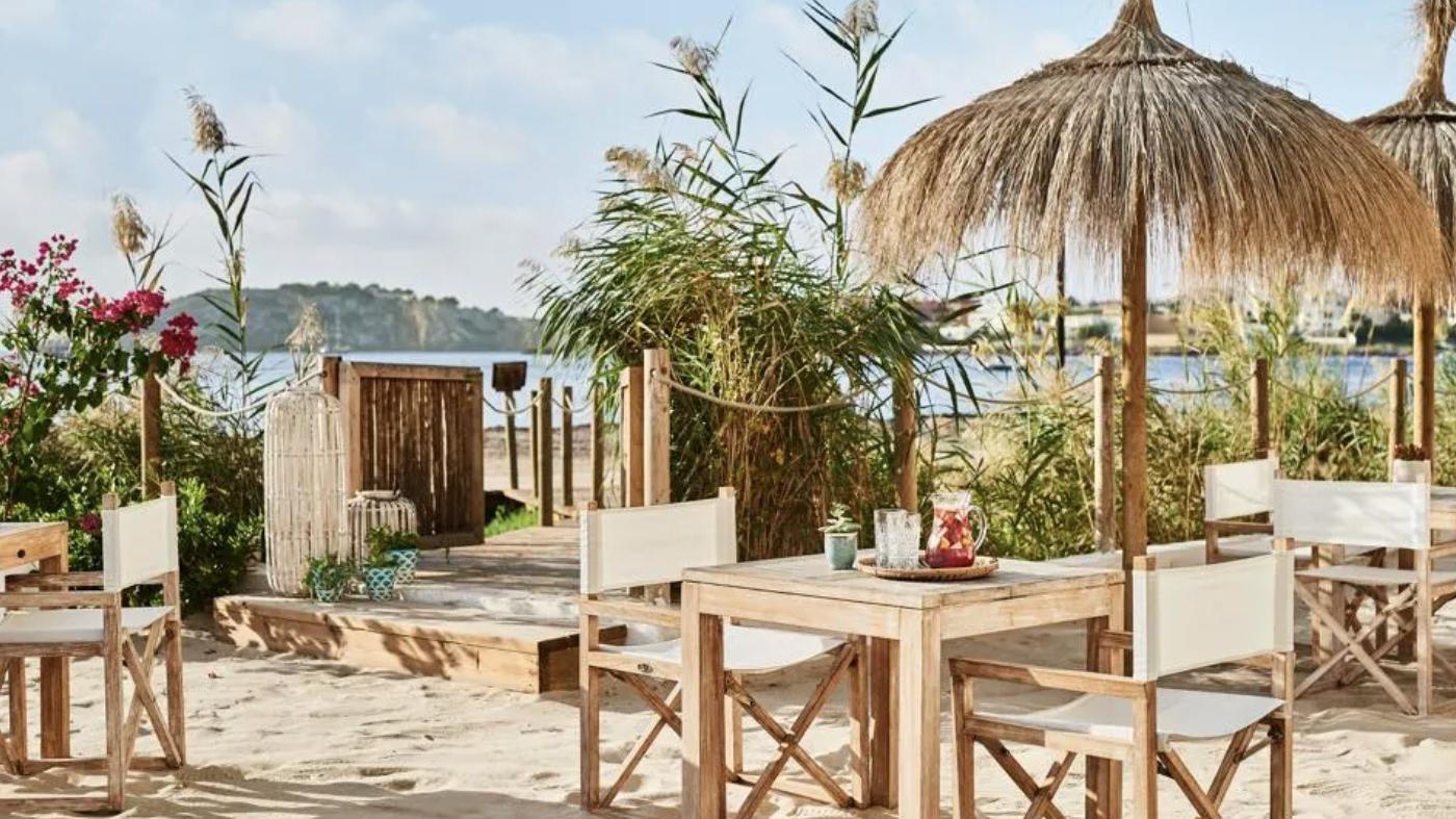Tables are set on the beach at the Chambao restaurant at Nobu Hotel Ibiza Bay.