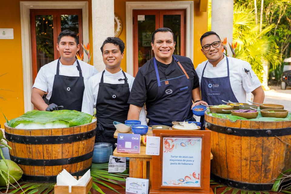 a group of chefs at a stand during Amigos del Mar event.