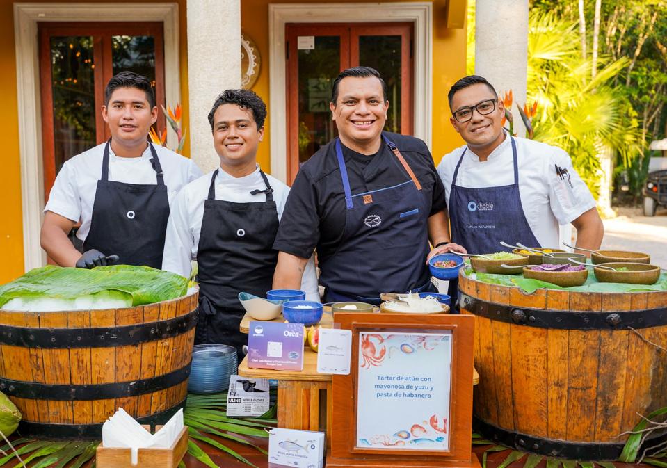 a group of chefs at a stand during Amigos del Mar event.