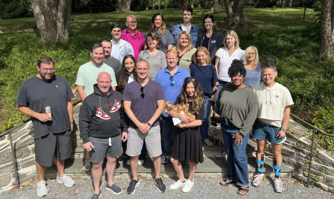 Members of growth equity firm Siddhi Capital pose for a photo outdoors.
