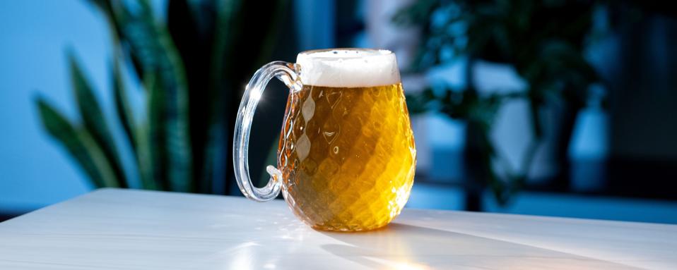 A Pretentious Foamy Boi glass, filled with golden lager.