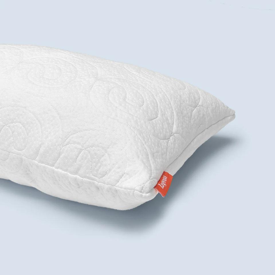 The Lagoon Fox Pillow against a gray background. 