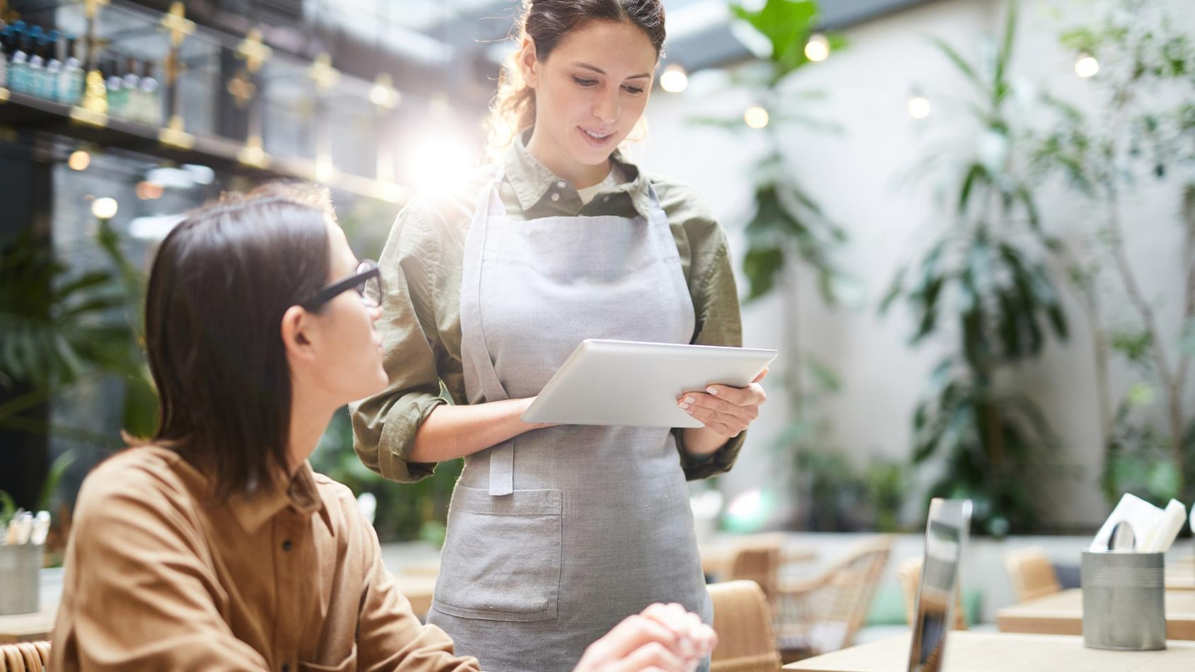 Waitress taking order from guest