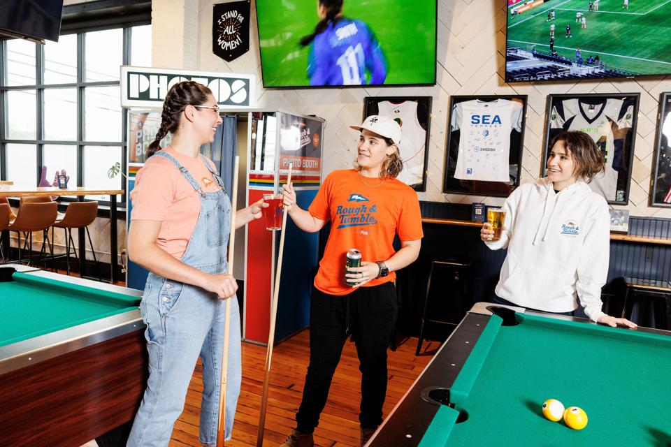 women playing pool in a sports bar