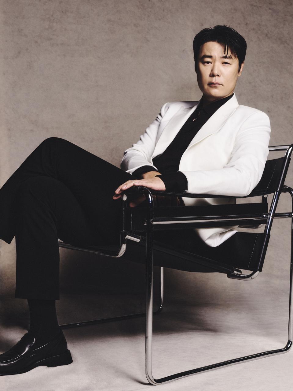 Choi Hyun-seok sitting in a chair