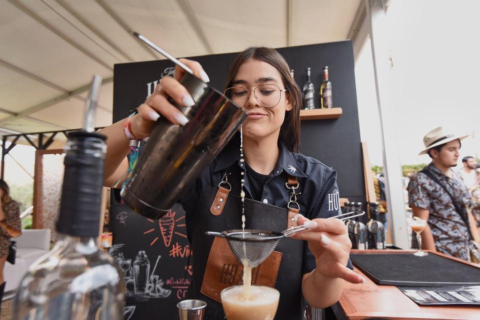 Barra México bartender pours a drink