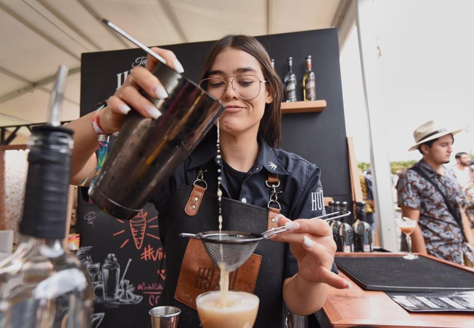 Barra México bartender pours a drink