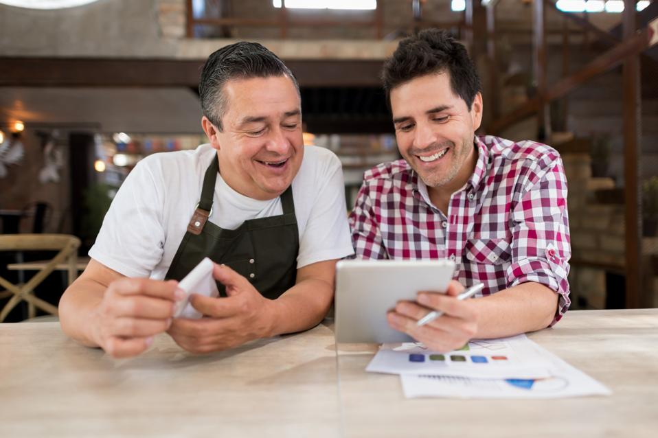 Men doing the books at a restaurant