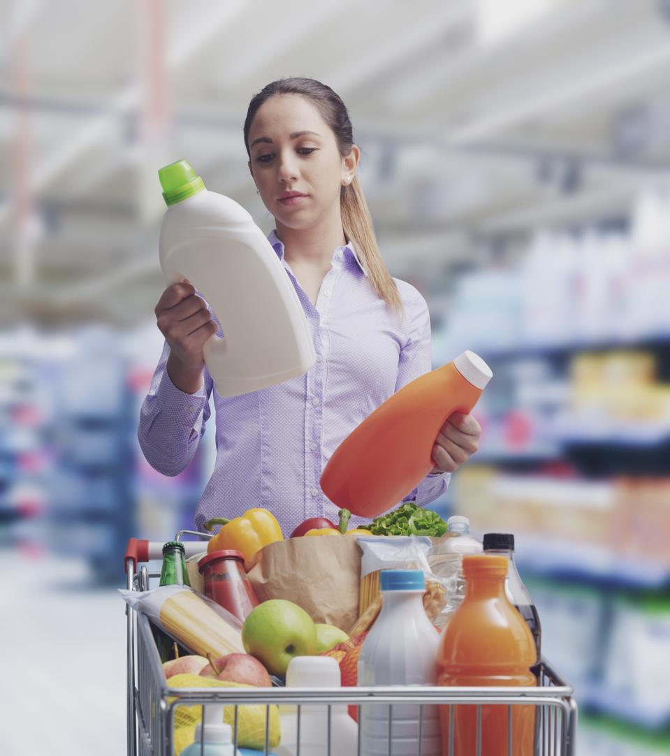 Woman comparing products at the supermarket