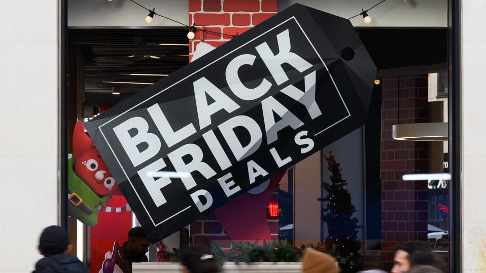 Signs advertising Black Friday sales. (Photo by Leon Neal/Getty Images)