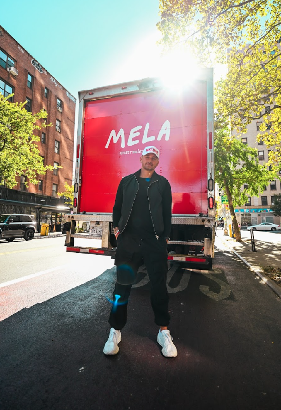 Mela CEO Dominic Purpura in front of a Mela truck