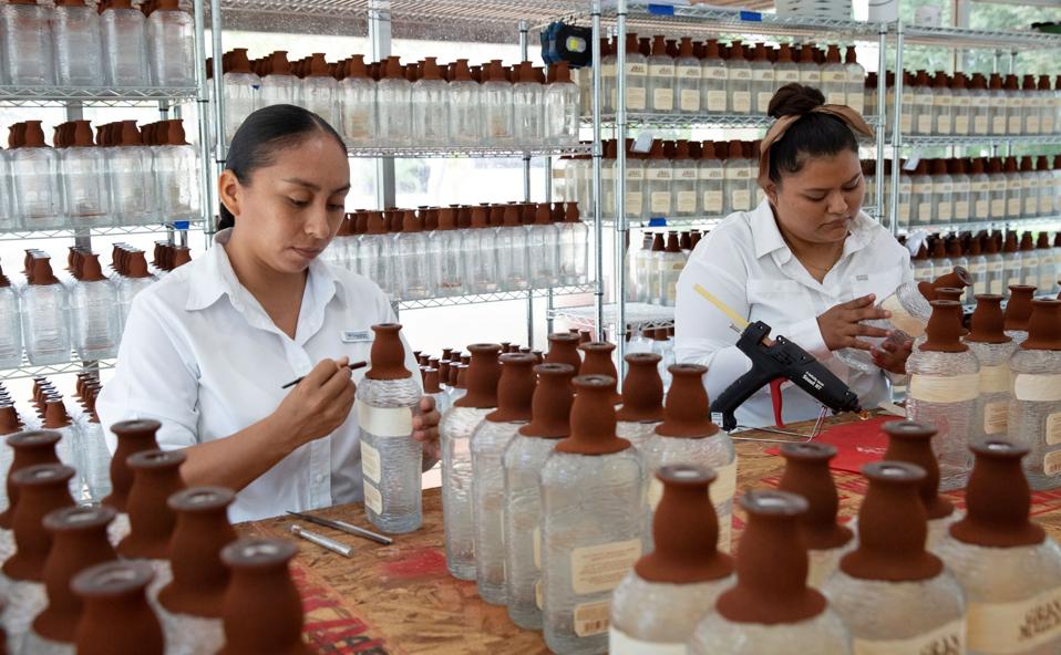 women decorating bottles