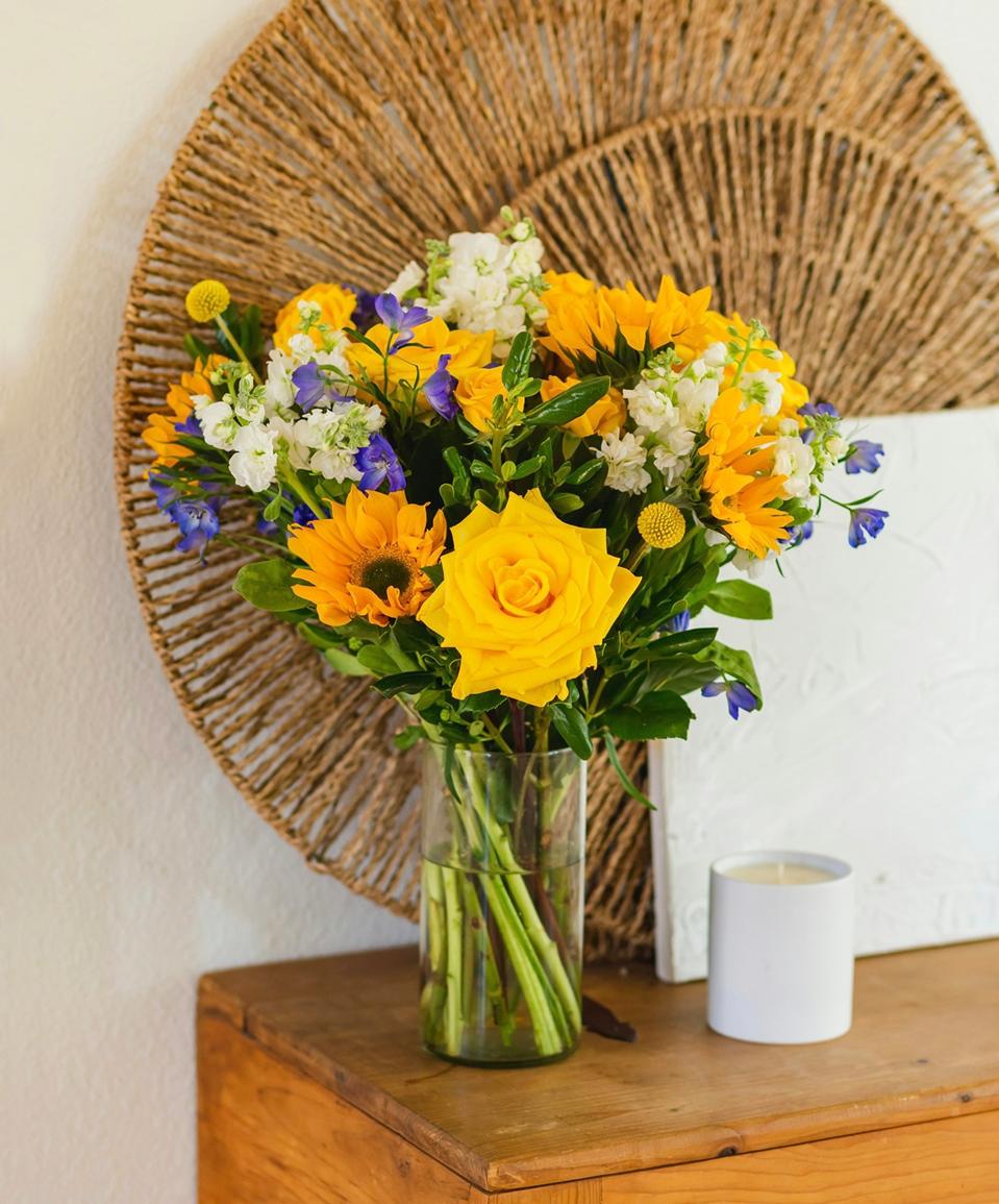 BloomsyBox Original Flower Subscription Club Bouquet on a wooden table.