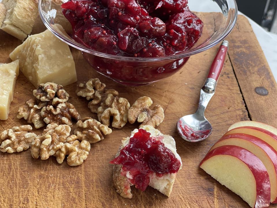 The perfect bite is a bit of Jasper Hill Port-Washed Cheese topped with a generous dollop of Fresh Cranberry Mostarda. In this photograph by Elizabeth Karmel is slice of baguette with a slice of Jasper Hill Sandeman Port-Washed Cheese topped with a generous dollop of Fresh Cranberry Mostarda.