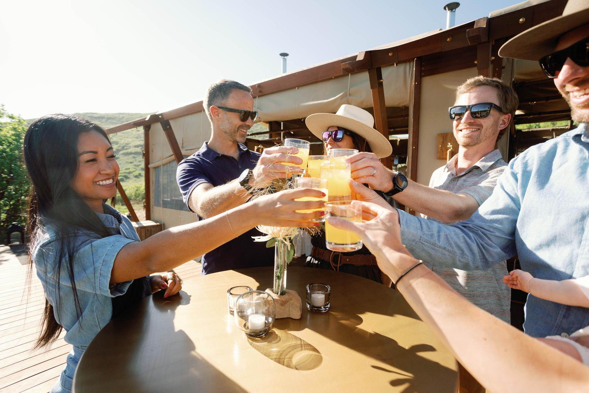 Guests at The Lodge at Blue Sky, Auberge Resorts Collection enjoying a toast in the WildTent