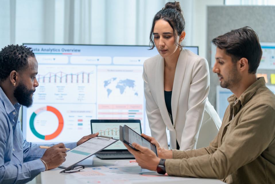 Increase credibility and Trust in communication to build Powerful Relationships. Business teamwork presented to their customer in a board room. They are discussing a business project over info-graphic data on a screen in a business office.