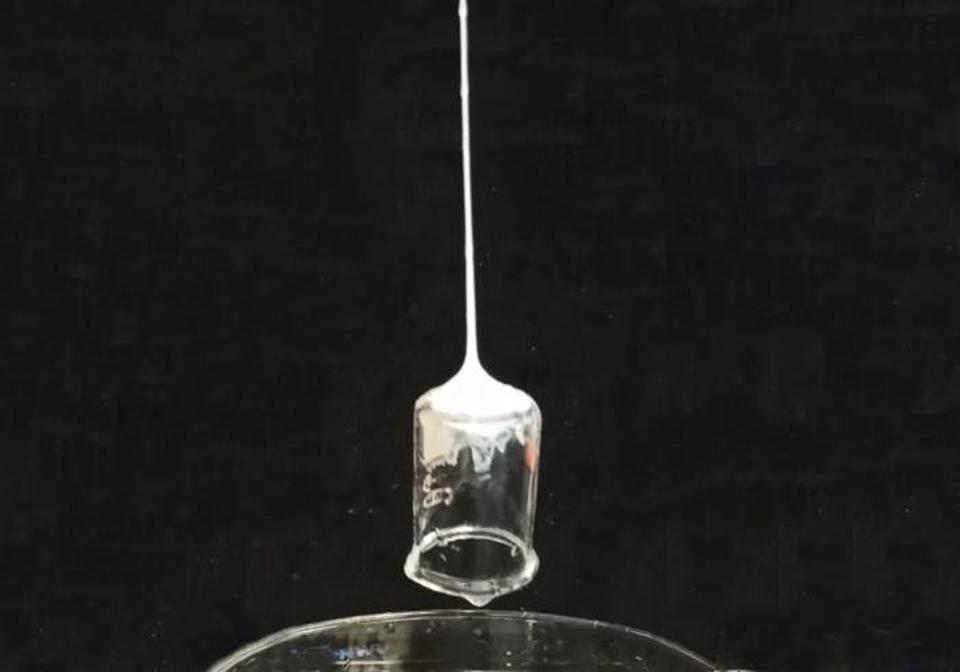 The web fluid developed by Tufts researchers here seen suspending a beaker in air.