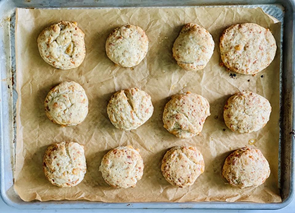 These homemade cheese and pepper biscuits fresh out of the oven are irresistible. The photo taken by Elizabeth Karmel show 12 biscuits shot overhead in the sheet pan that they were baked on. 